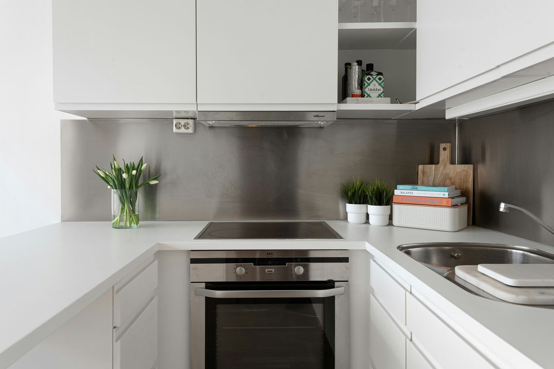 sleek modern NYC new development apartment interior with quartz countertops, high-gloss cabinetry, and stainless appliances, natural light