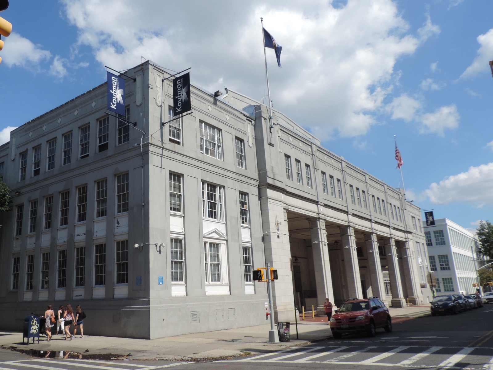 Kaufman Astoria Studios corner entrance on 35th Avenue with its columned portico and Kaufman banners