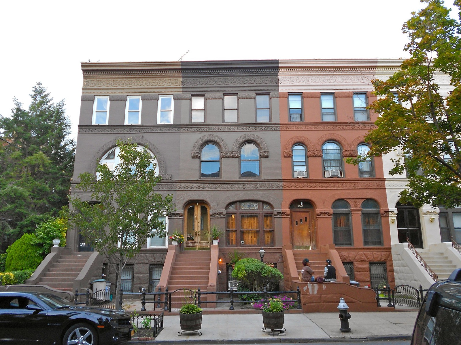 The 200 block of Decatur Street in the Stuyvesant Heights Historic District showing uniform brownstone facades with Romanesque Revival details and mature street trees