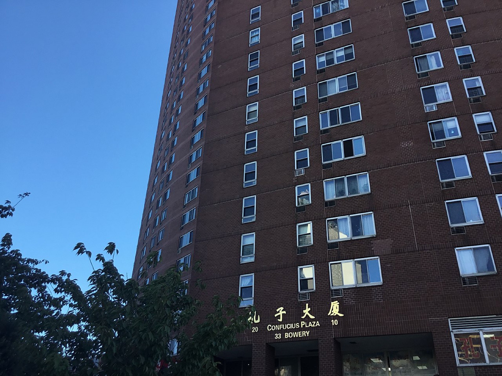 Confucius Plaza tower and the bronze Confucius statue at the corner of Bowery and Division Street in Chinatown