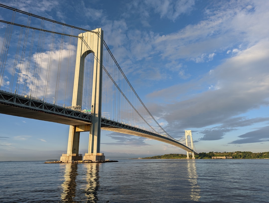 The Verrazzano-Narrows Bridge as seen from the harbor, the long suspension span connecting the Fort Hamilton anchorage in Brooklyn to the Fort Wadsworth anchorage in Staten Island