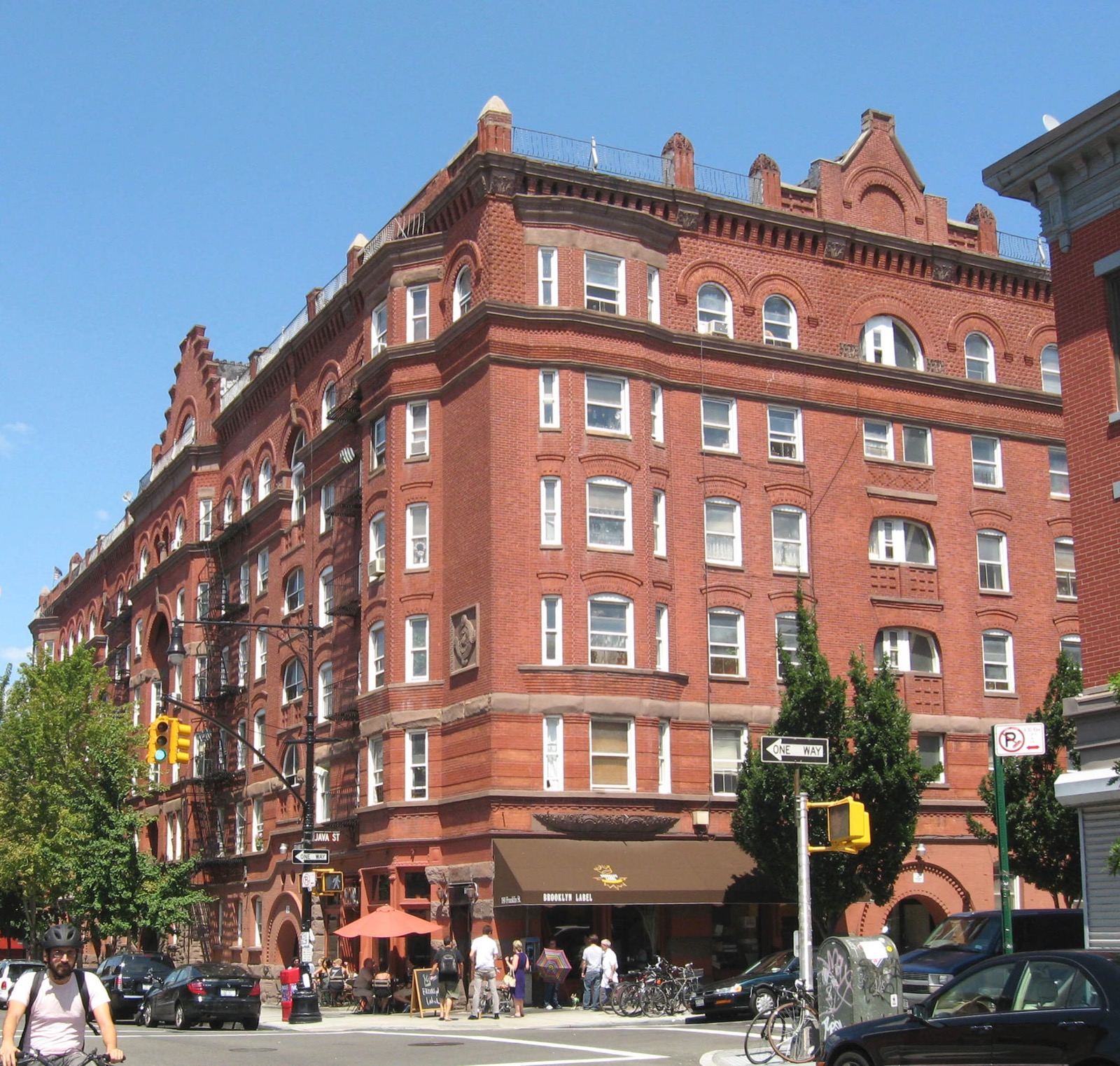The Astral Apartments at 184 Franklin Street, a block-long Queen Anne building with terra cotta detailing and a central three-story round arch, built by oil magnate Charles Pratt in 1886 as model housing for his refinery workers