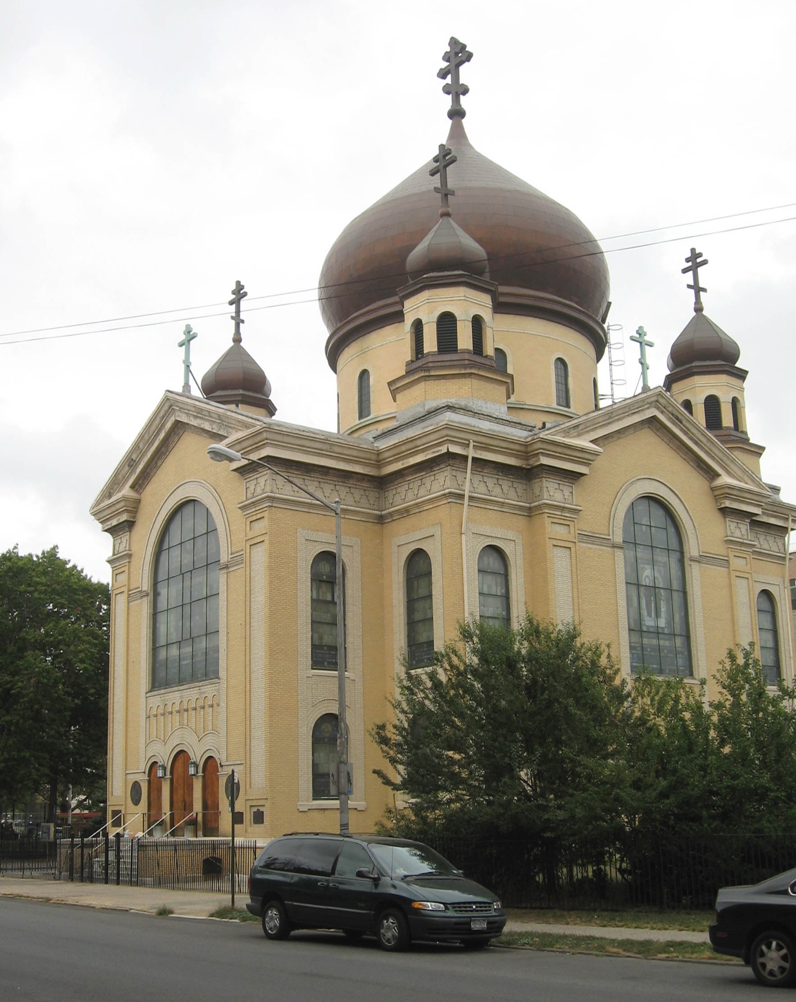 The Russian Orthodox Cathedral of the Transfiguration in Greenpoint, the only Byzantine Revival building in New York City, with five copper cupolas topped by Patriarchal crosses against the sky