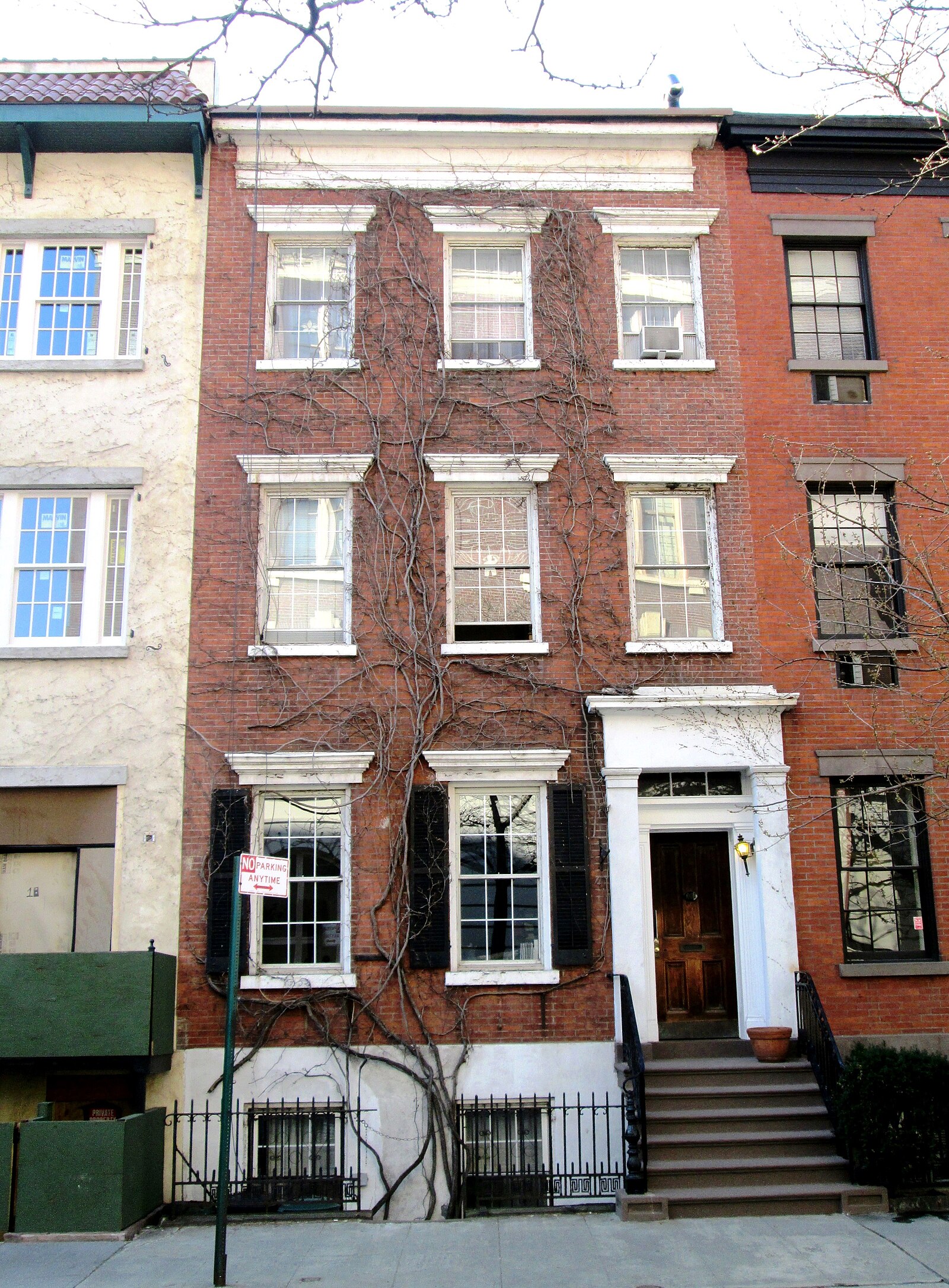 A Federal-era townhouse on Grove Street in the West Village, showing the scale and architectural detail of the neighborhood's 19th-century residential streets