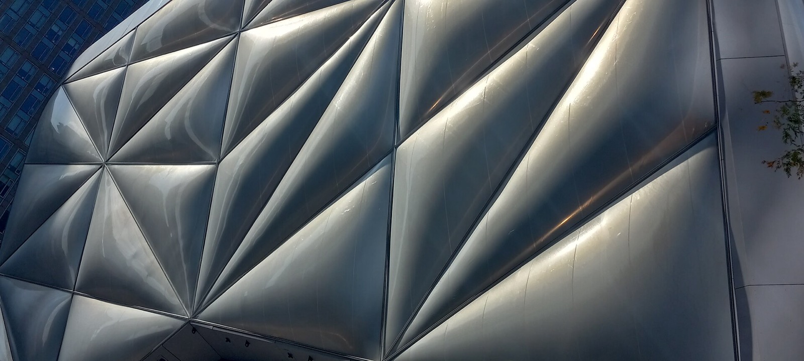 The Shed arts center at Hudson Yards with its distinctive translucent ETFE outer shell, nestled at the base of the residential towers