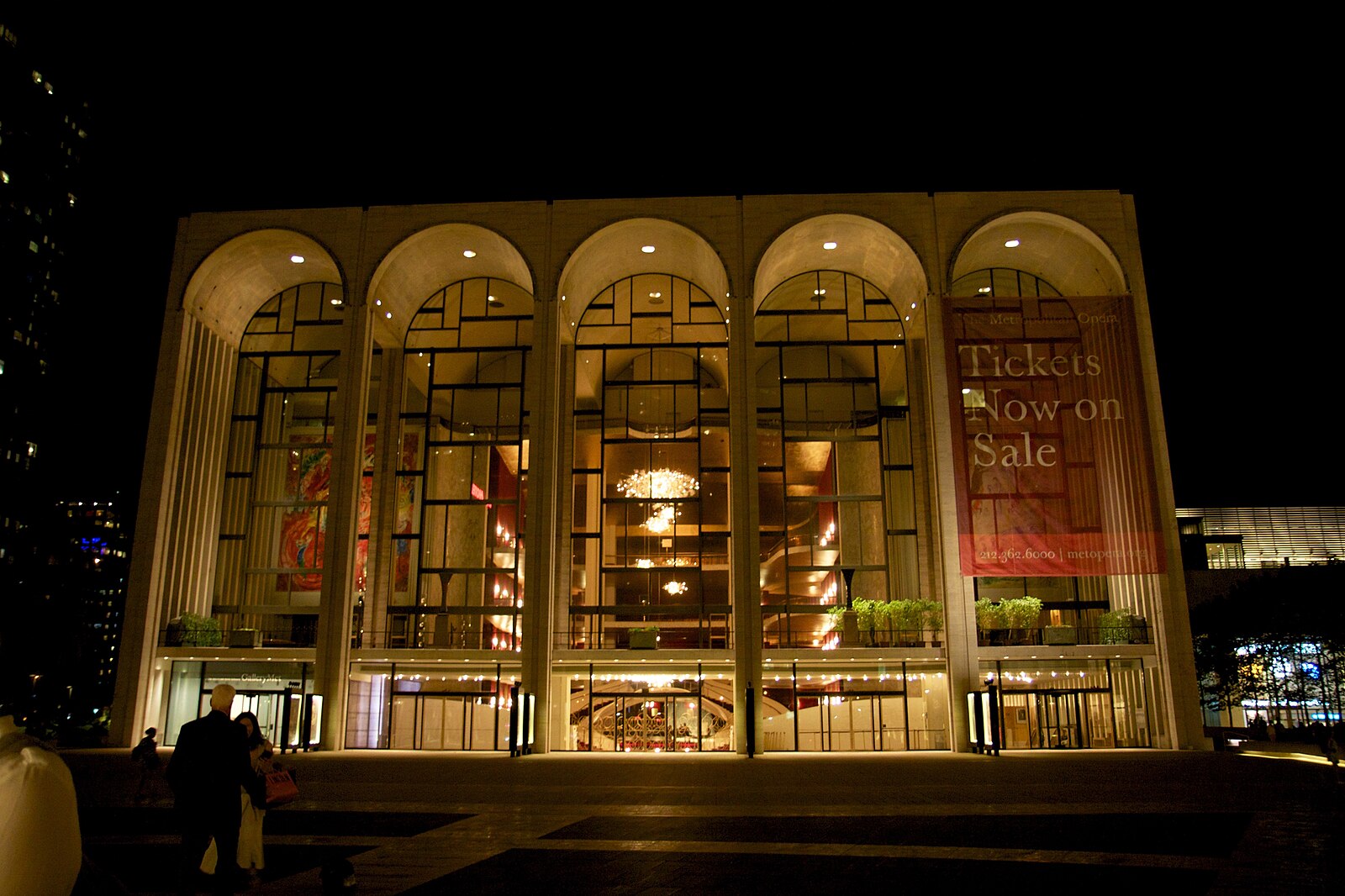 The Metropolitan Opera House at Lincoln Center, designed by Wallace K. Harrison and completed in 1966, with its characteristic arched windows revealing the lobby and Chagall murals from the plaza