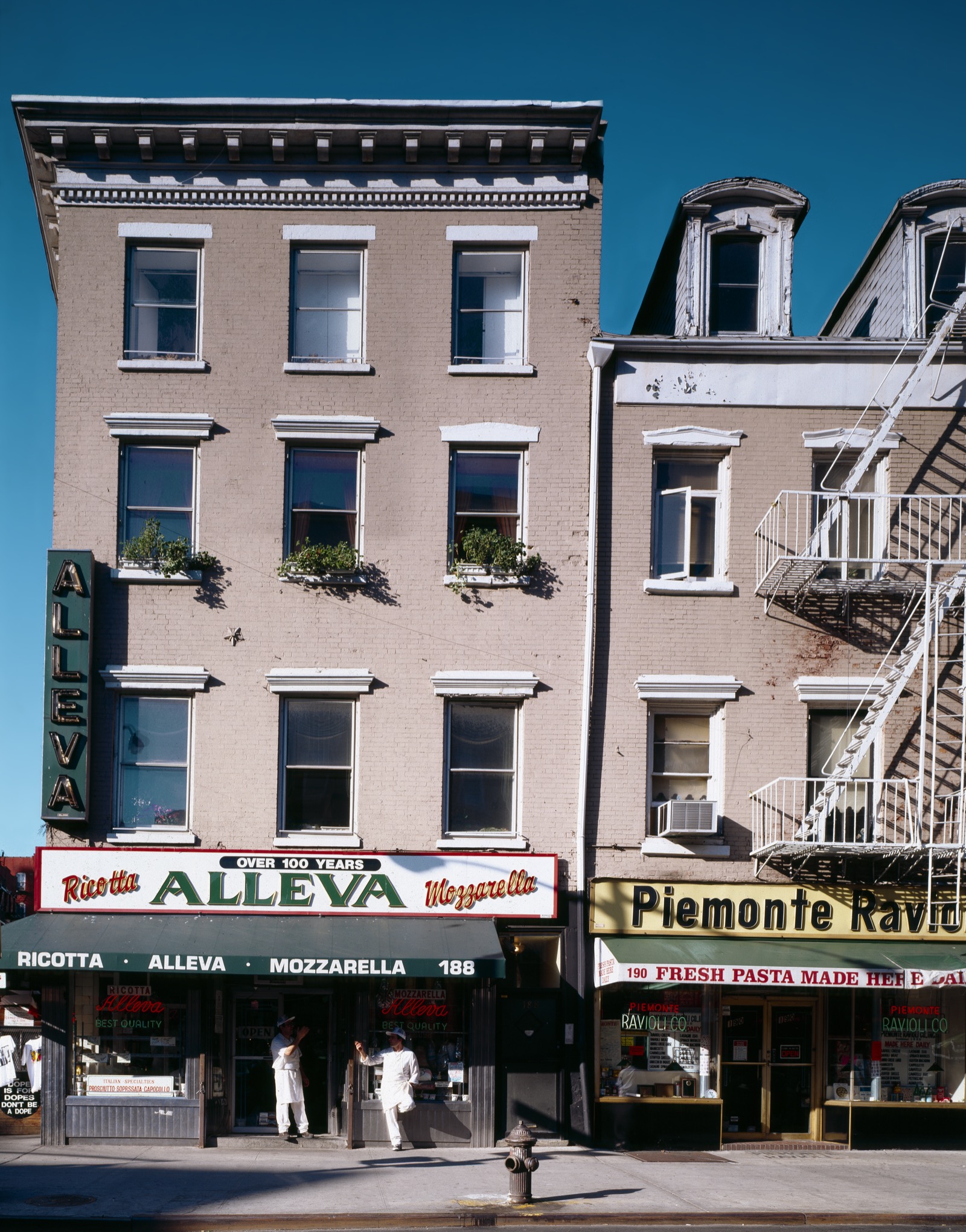 A Little Italy street in Manhattan showing the neighborhood's tenement buildings and storefronts