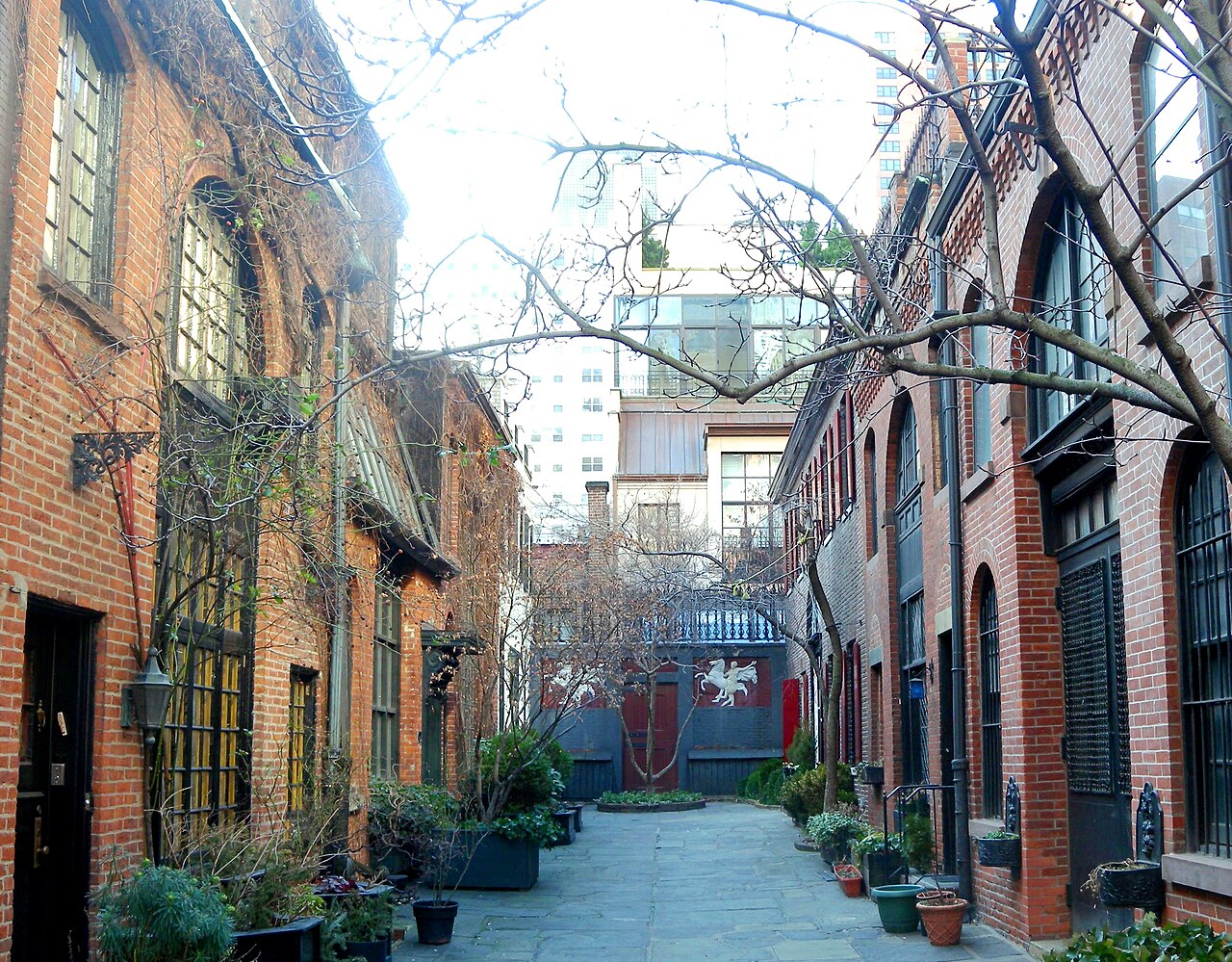 Brick carriage houses lining the private courtyard of Sniffen Court on East 36th Street in Murray Hill, Manhattan