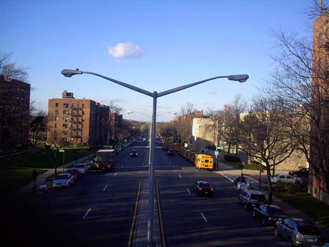 Bell Boulevard seen from the old Vanderbilt Motor Parkway bridge in Oakland Gardens, showing suburban residential streets under a tree canopy