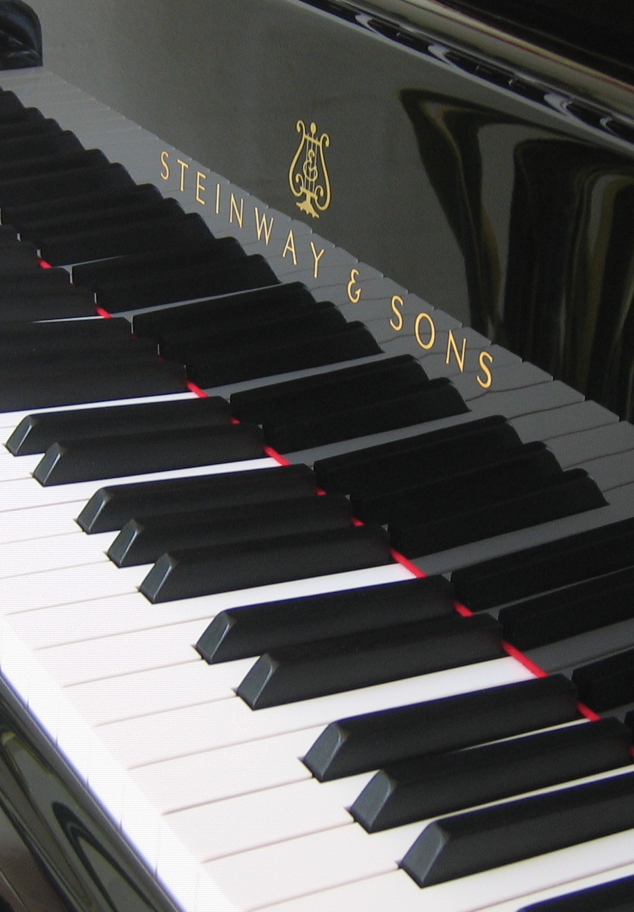 The keyboard and action mechanism of a Steinway concert grand piano, showing the precision craftsmanship that requires approximately one year of production at the Queens factory