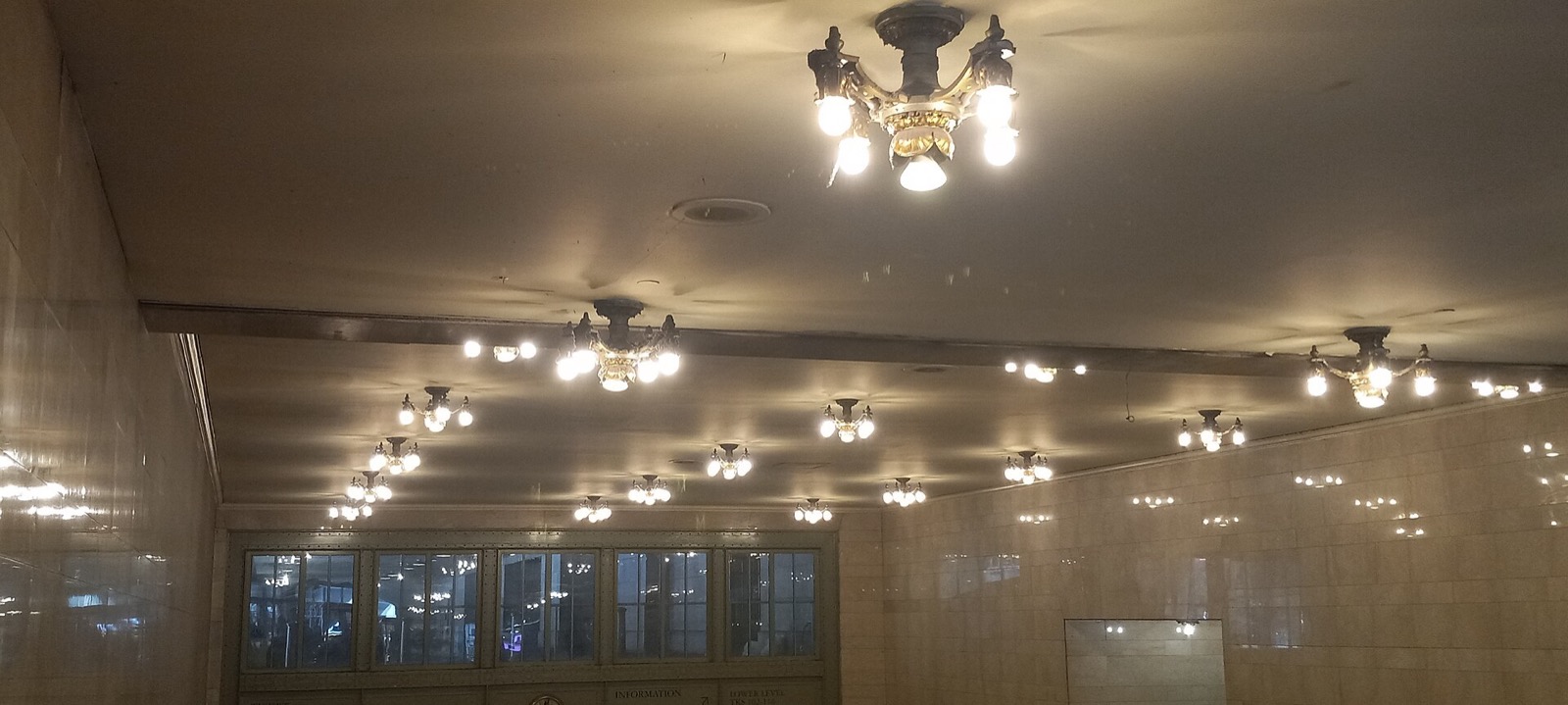 Grand Central Terminal's main concourse interior in Turtle Bay, Manhattan, with the painted celestial ceiling visible above the arched windows