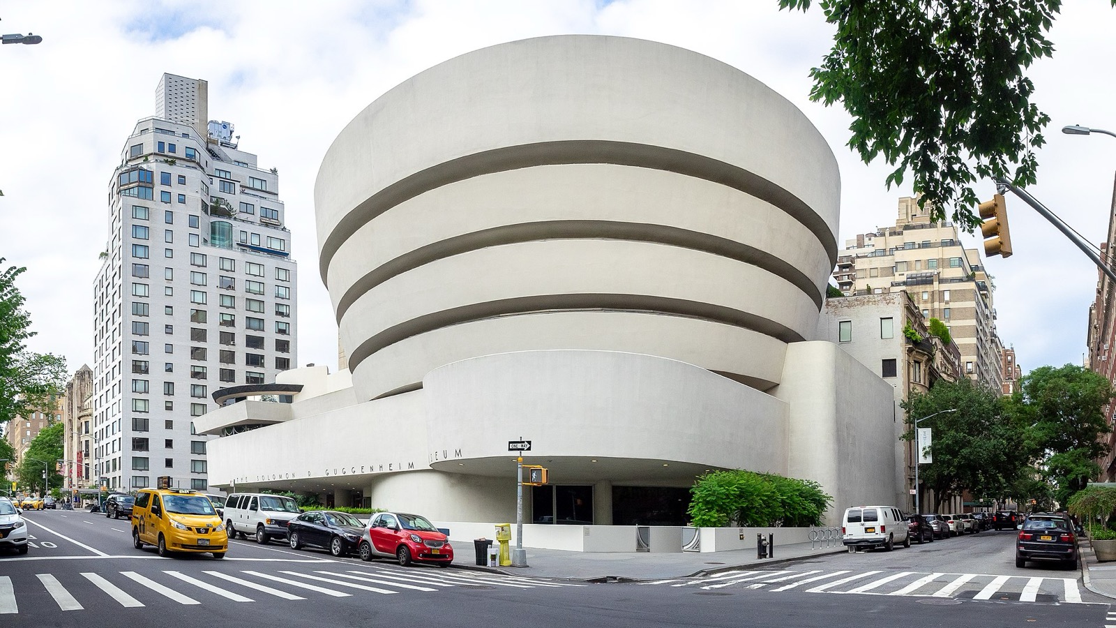 Frank Lloyd Wright's Solomon R. Guggenheim Museum on Fifth Avenue, showing the distinctive spiraling white concrete rotunda against the Upper East Side skyline