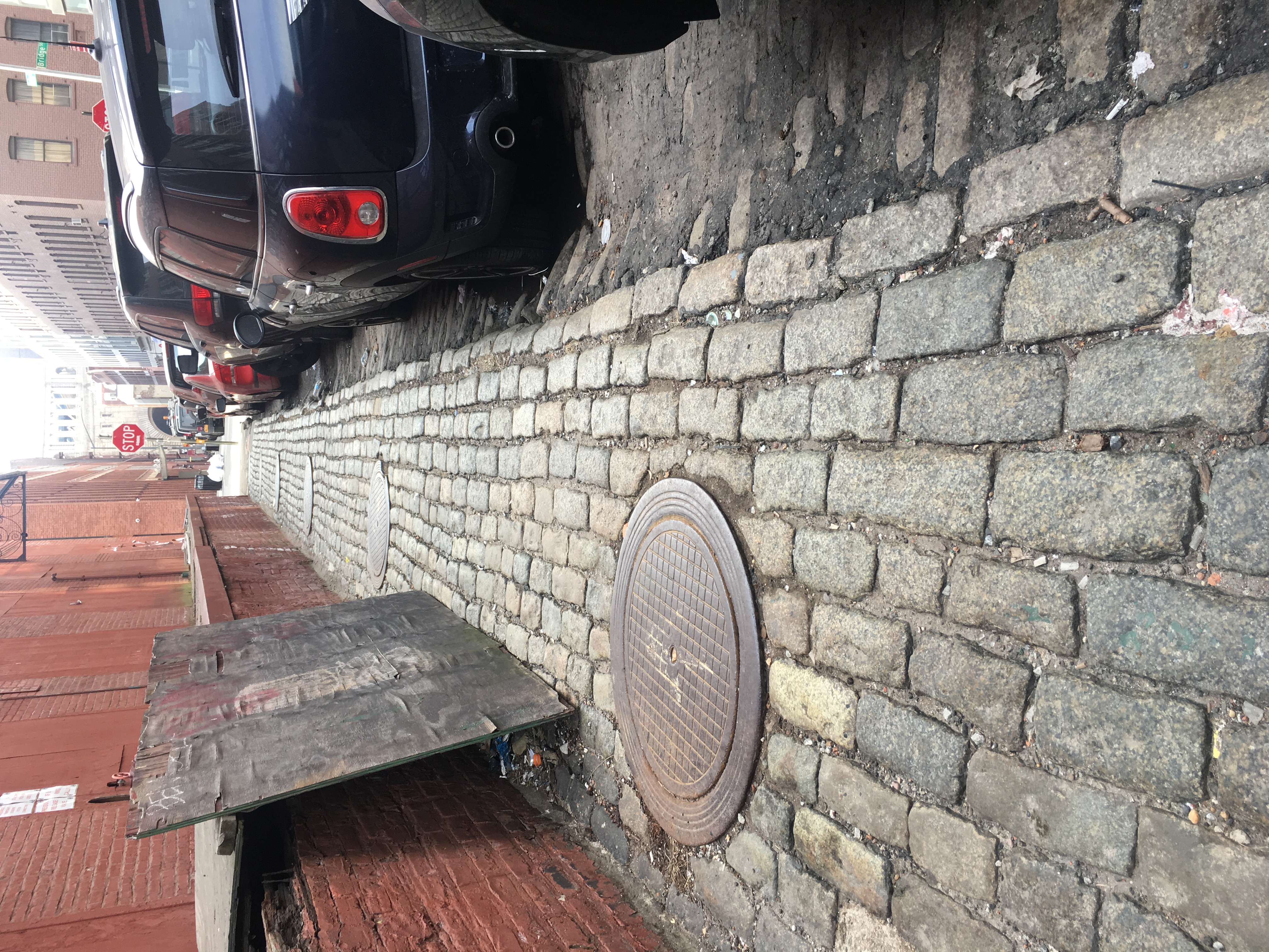 Belgian block granite paving at the edge of Vinegar Hill contrasted against asphalt at the neighborhood boundary in Brooklyn
