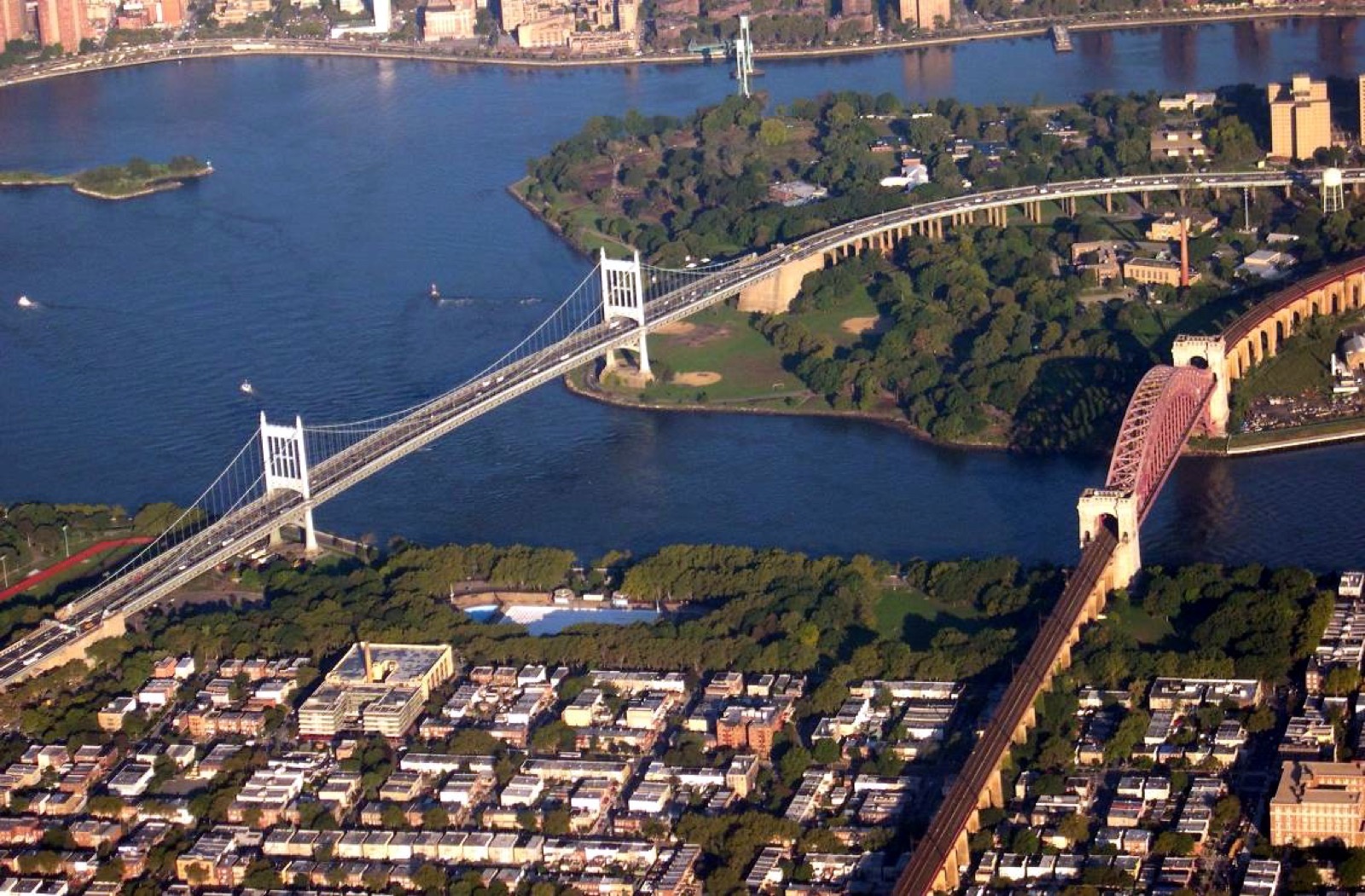 Hell Gate and the Triborough Bridge viewed from the Queens side, with Wards Island visible in the waterway where the East River, Harlem River, and Long Island Sound converge