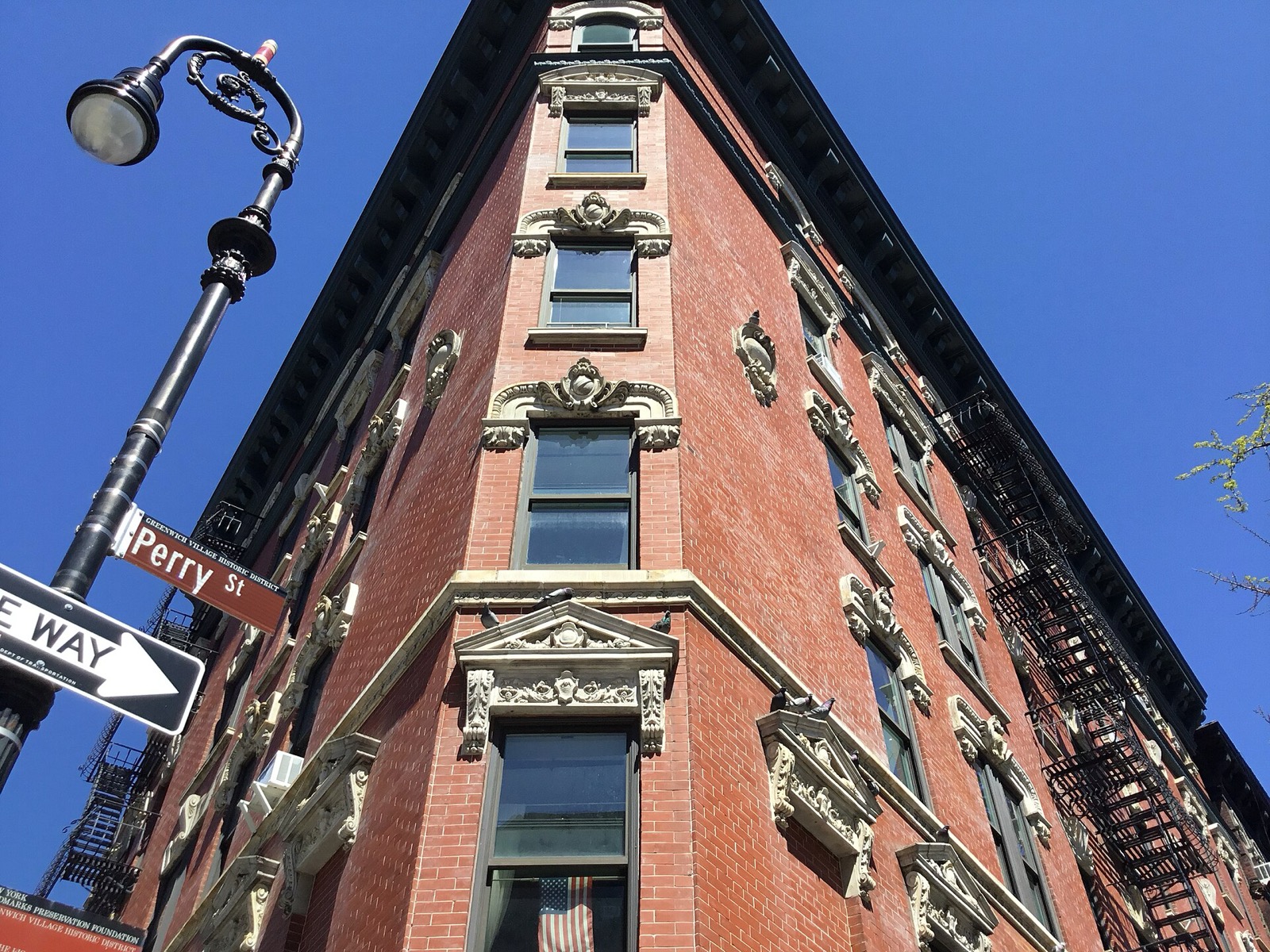 Tree-lined residential street in the West Village, Manhattan, showing the low-scale Federal and Greek Revival rowhouse fabric that defines the neighborhood