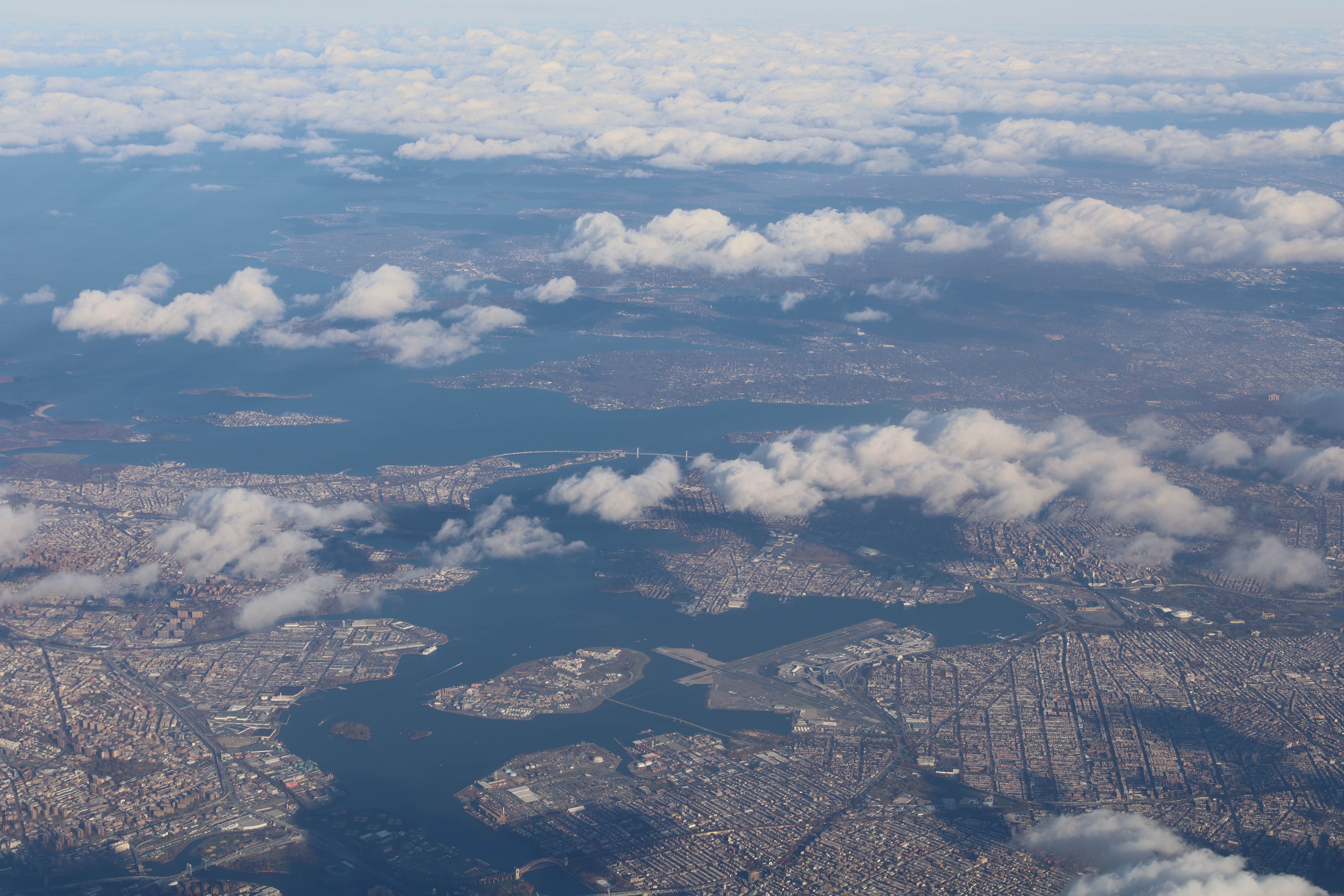 The Long Island Sound North Shore waterfront in spring, showing rocky shoreline, open water, and the Connecticut landscape visible across the Sound on a clear day