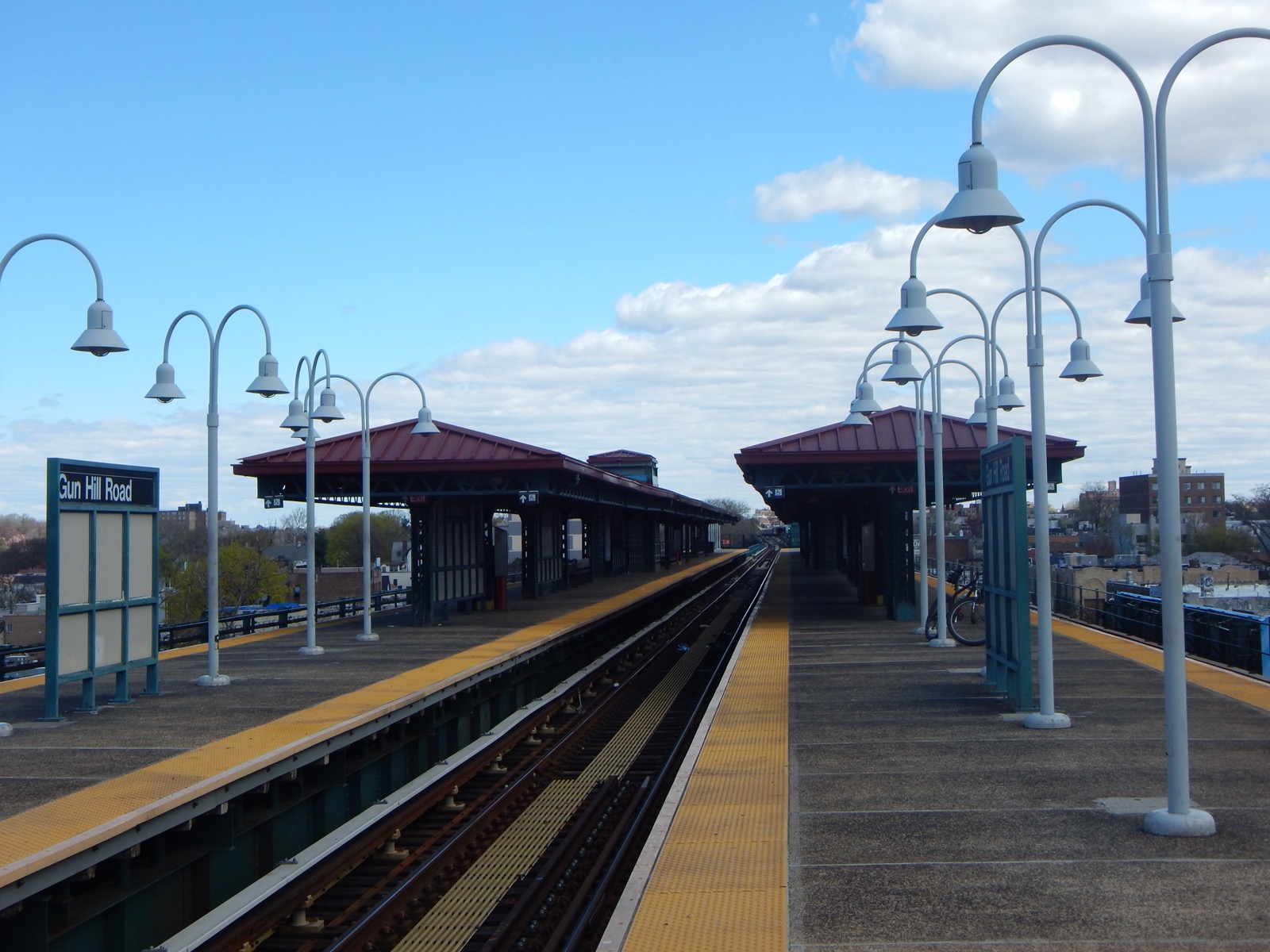 The Gun Hill Road elevated subway station on the IRT White Plains Road Line showing the platform structure and tracks above the commercial street below